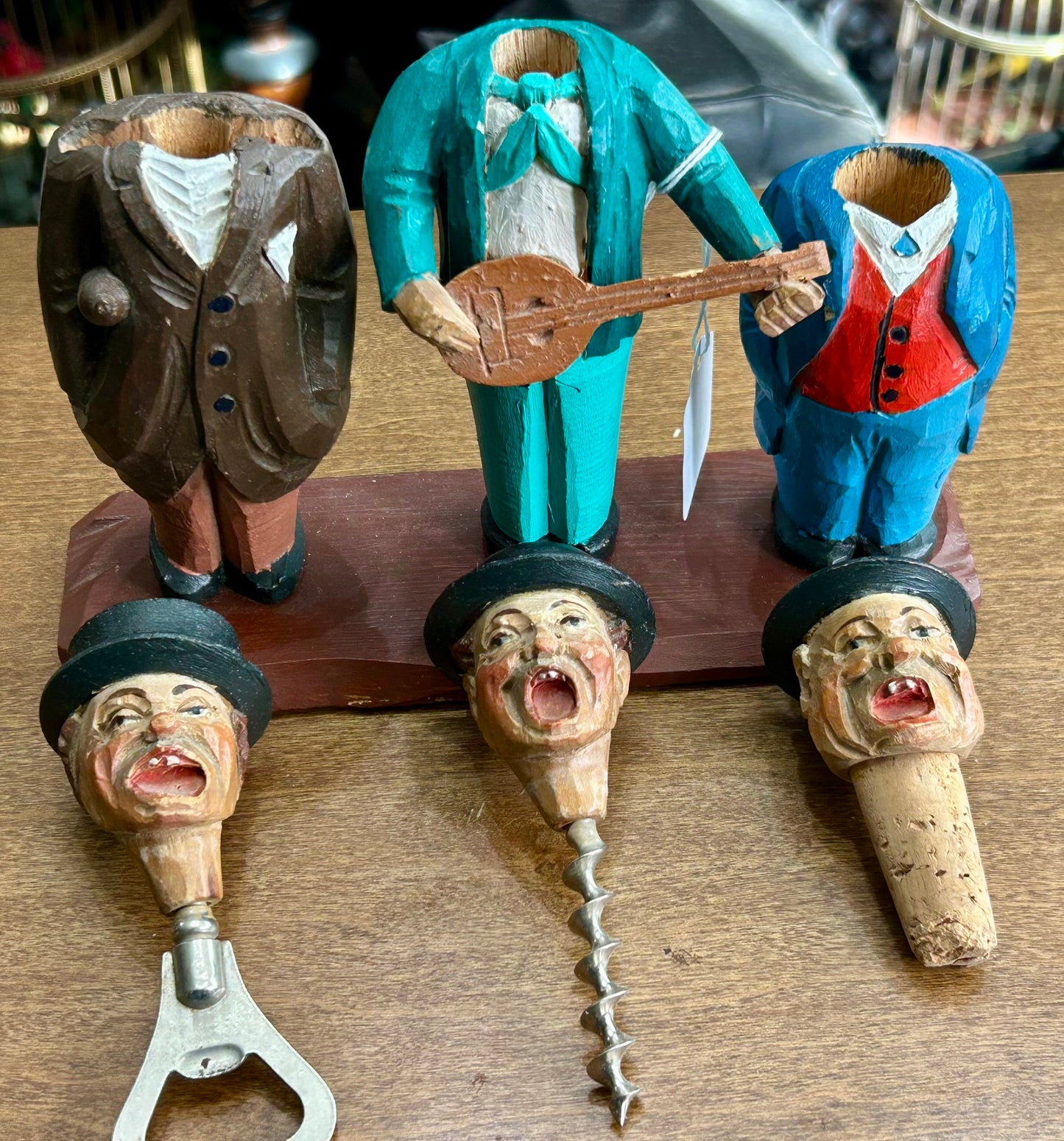 CARVED WOODEN FIGURES OF CORK SCREW, BOTTLE OPENER AND BOTTLE STOPPER