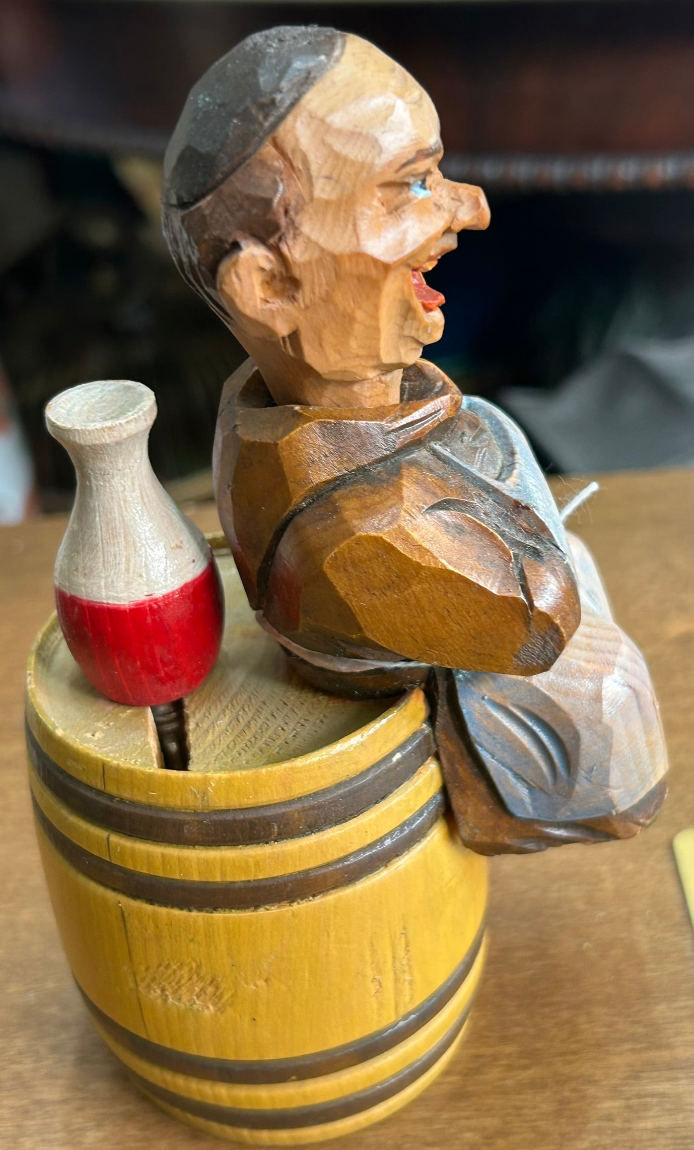 CARVED WOODEN FIGURAL CORKSCREW OF MONK SITTING ON BARREL WITH BOTTLE OPENER