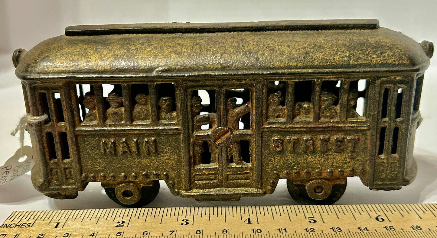 ANTIQUE CAST IRON TROLLY STILL BANK WITH PEOPLE