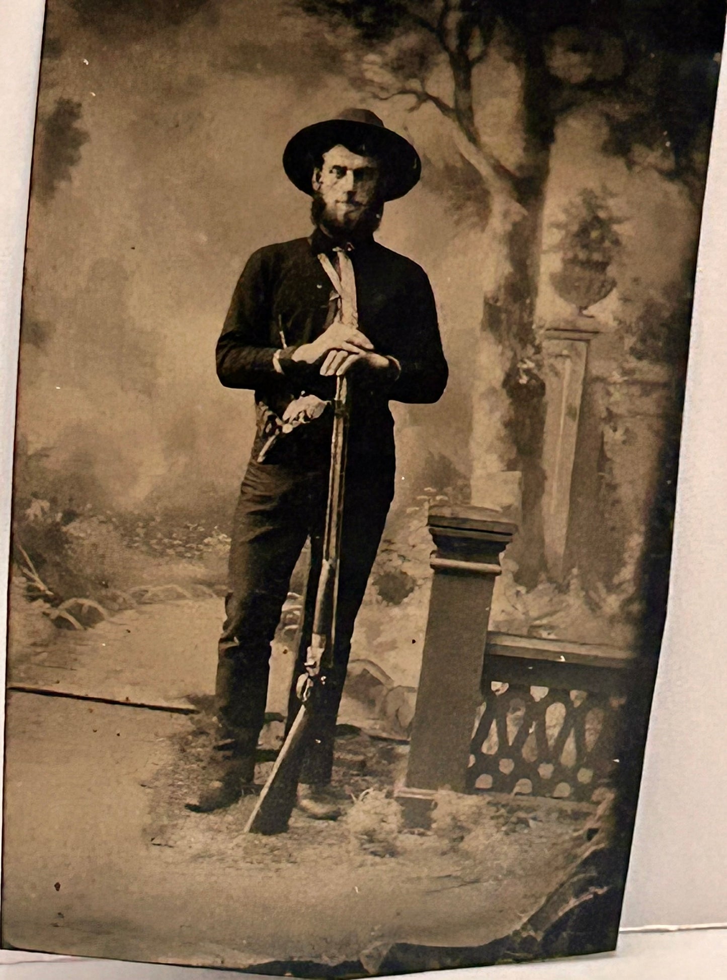 TINTYPE OF MAN WITH SHOTGUN AND PISTOL POSING