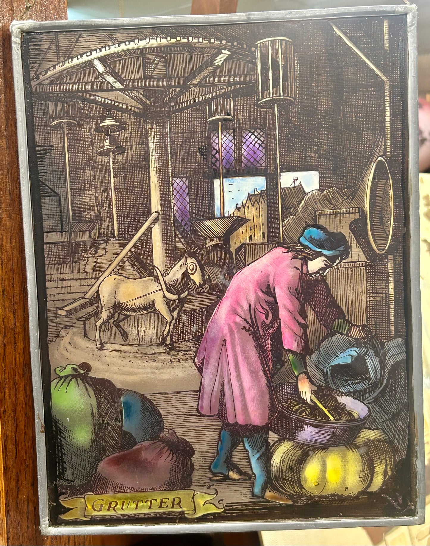 HAND DECORATED HANGING GLASS PANEL OF "GRUTTER" OR MILLER OCCUPATION