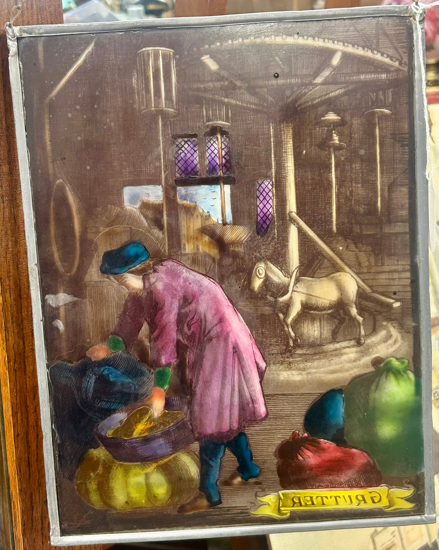 HAND DECORATED HANGING GLASS PANEL OF "GRUTTER" OR MILLER OCCUPATION