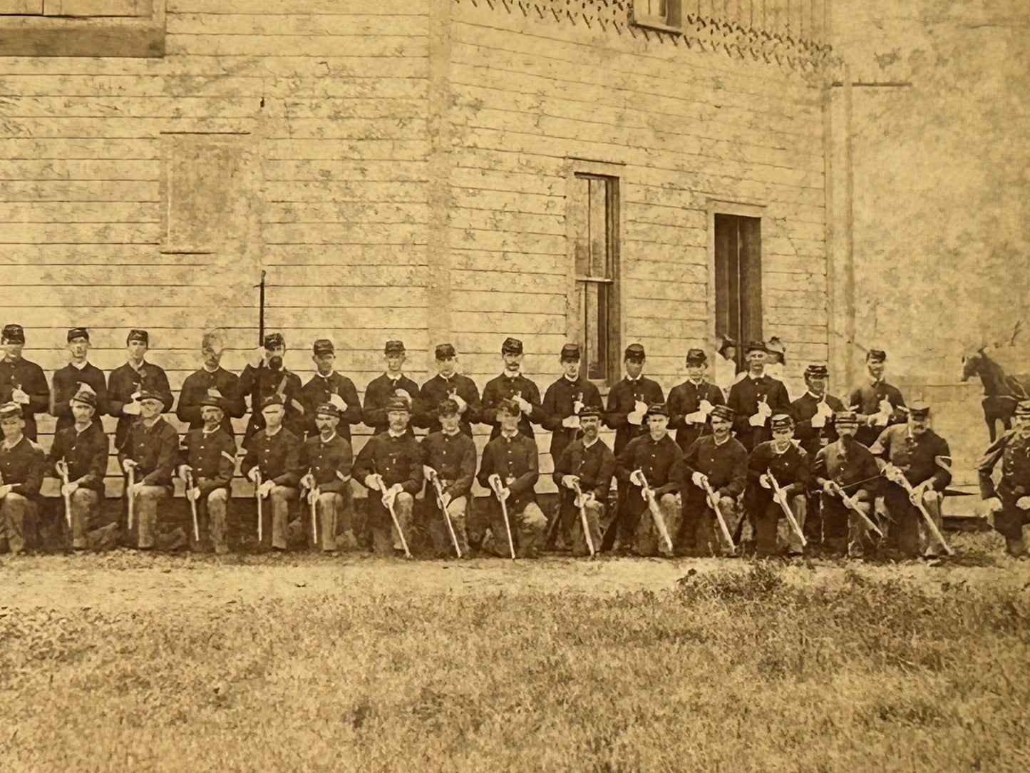 ON HOLD AND NOT SOLD YET. LARGE GROUP OF SOLDIERS IN FRONT OF FORT BUILDING BY FREMONT NEBR. PHOTOGRAPHER A. C. HULL