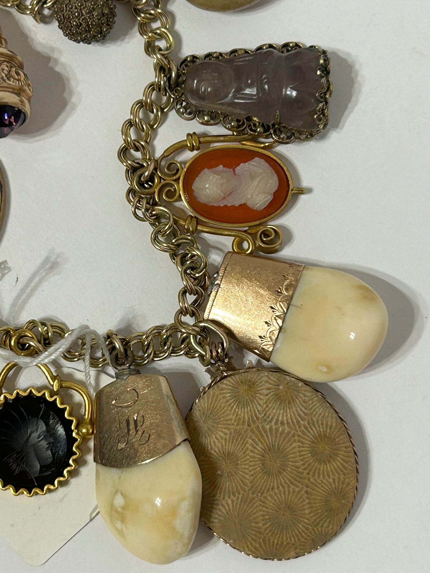 ANTIQUE CHARM BRACELET WITH TWENTY CHARMS INCLUDING ELKS TEETH AND CAMEOS,
