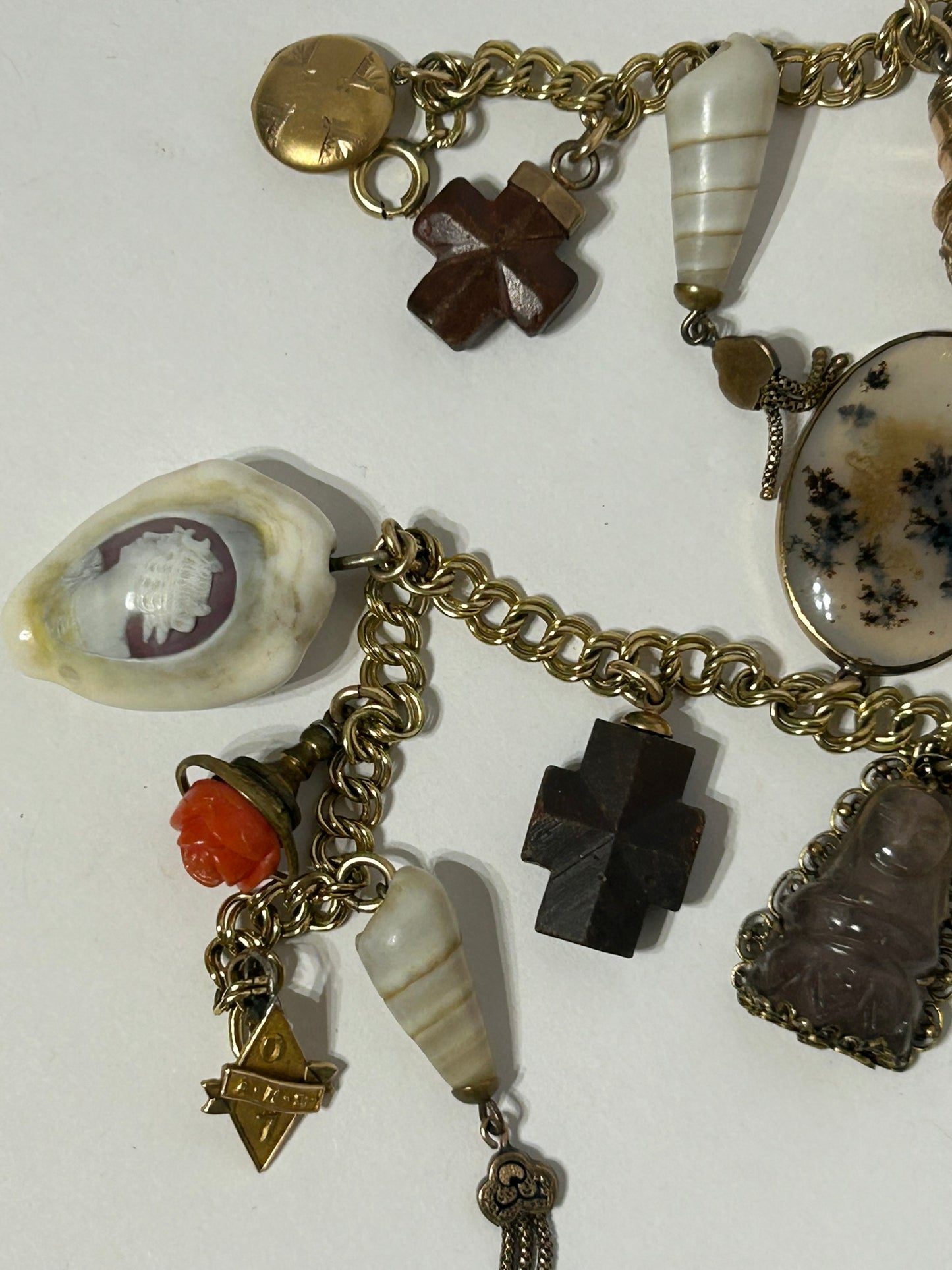 ANTIQUE CHARM BRACELET WITH TWENTY CHARMS INCLUDING ELKS TEETH AND CAMEOS,