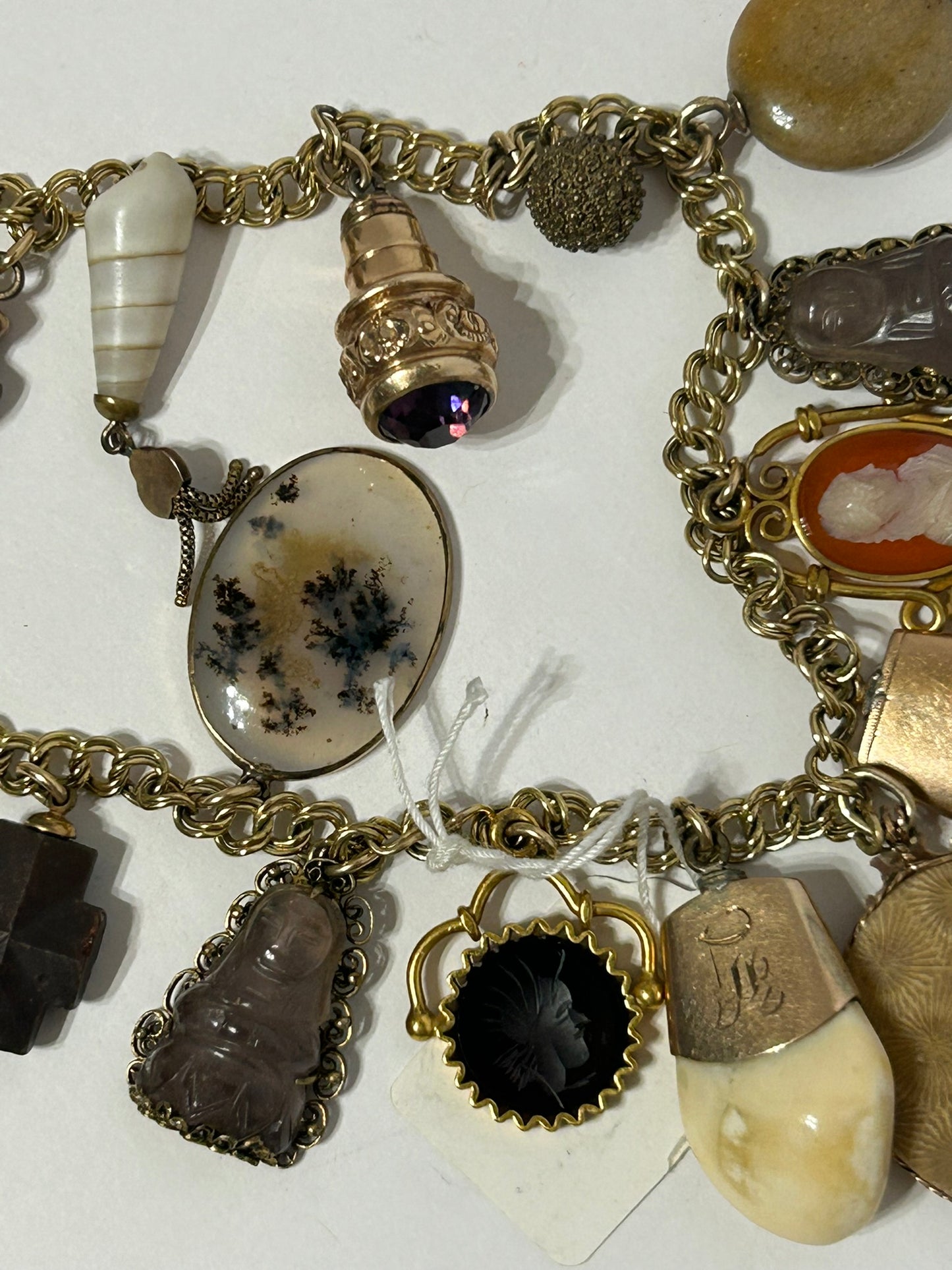 ANTIQUE CHARM BRACELET WITH TWENTY CHARMS INCLUDING ELKS TEETH AND CAMEOS,