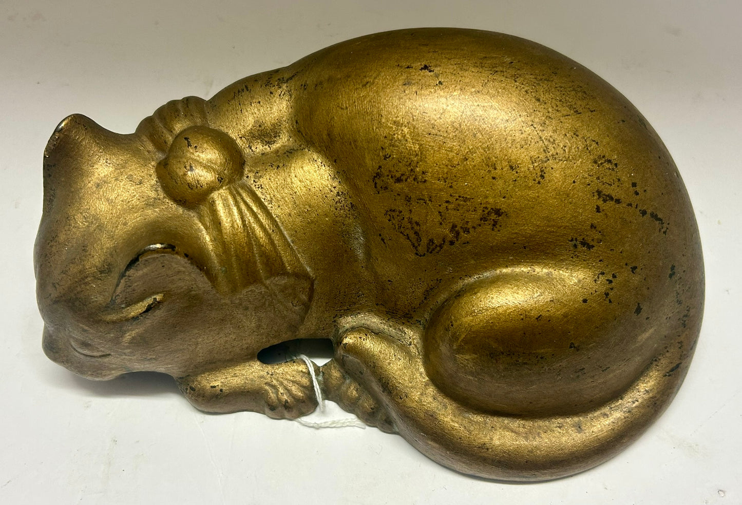 CAST IRON CAT WITH BOW LAYING DOWN ANTIQUE DOORSTOP