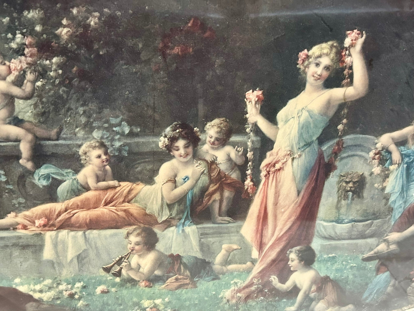 LARGE EARLY 1900'S OVAL PICTURE OF CLASSICAL LADIES AND CHILDREN FROLICKING IN FLOWER GARDEN