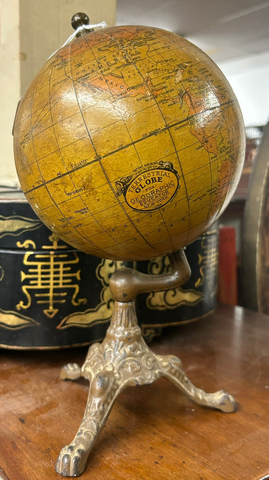 ANTIQUE WORLD GLOBE WITH THREE LEGGED IRON BASE