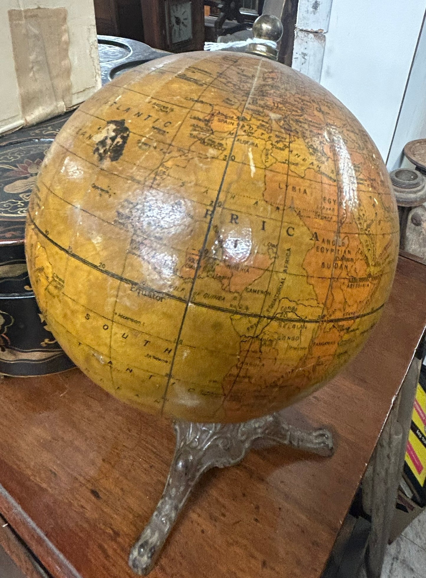 ANTIQUE WORLD GLOBE WITH THREE LEGGED IRON BASE