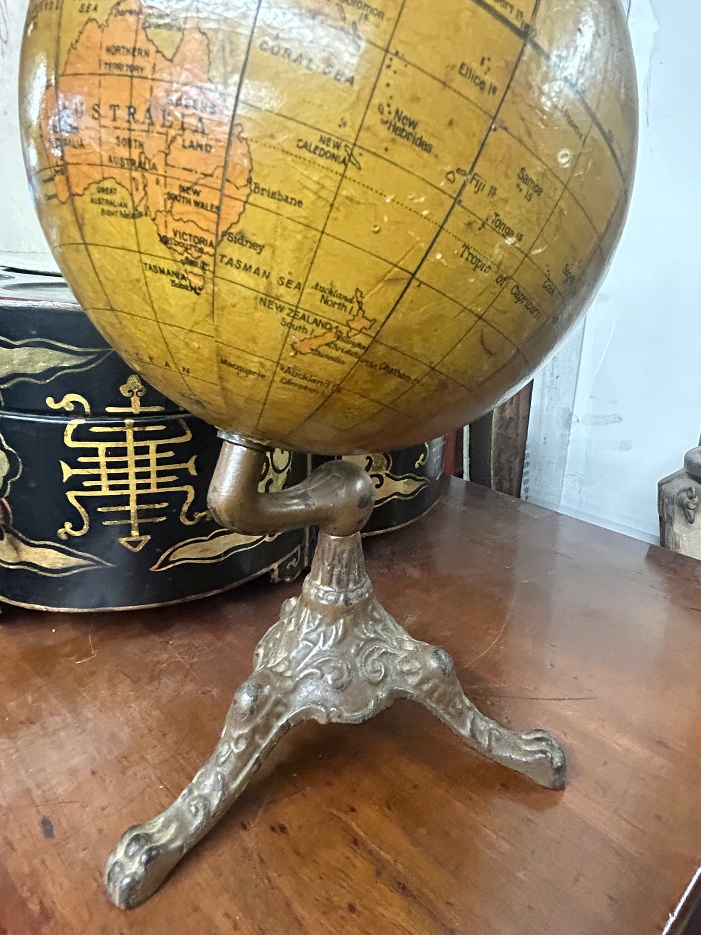 ANTIQUE WORLD GLOBE WITH THREE LEGGED IRON BASE
