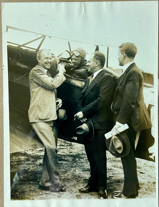 CHARLES LINDBERGH SITTING IN PLANE WITH AVIATION SECRETARIES