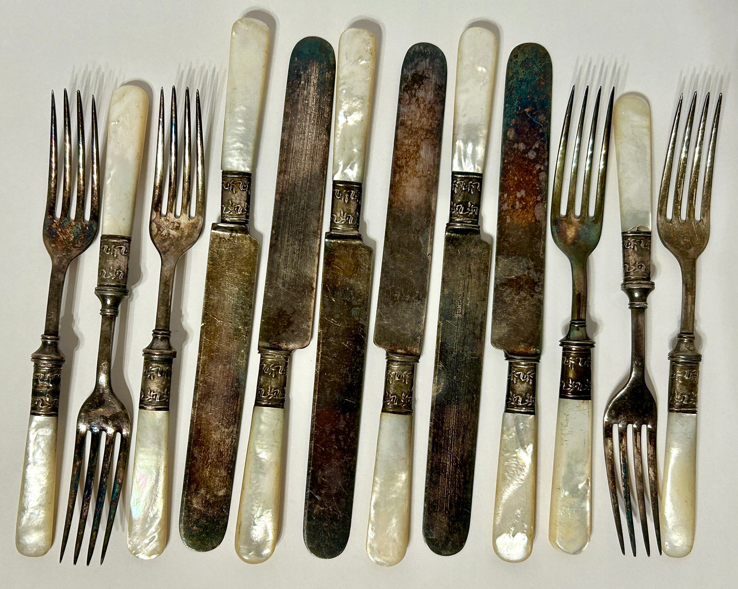 STERLING AND MOTHER OF PEARL HANDLED ANTIQUE SET OF TWELVE FORKS AND KNIVES