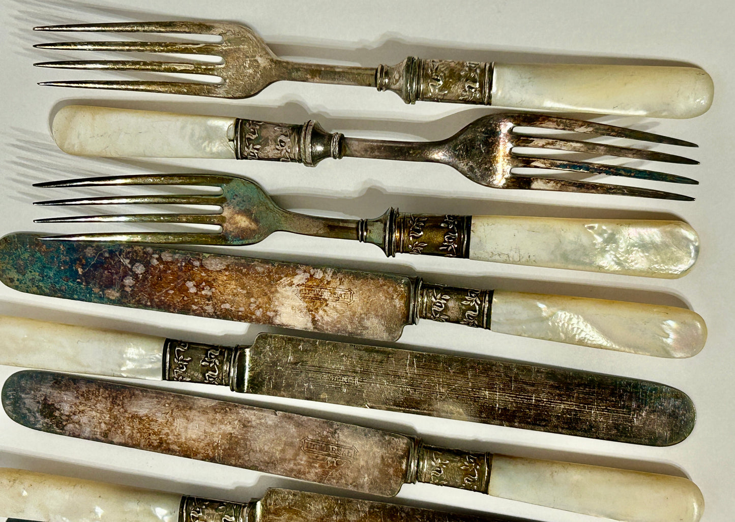 STERLING AND MOTHER OF PEARL HANDLED ANTIQUE SET OF TWELVE FORKS AND KNIVES