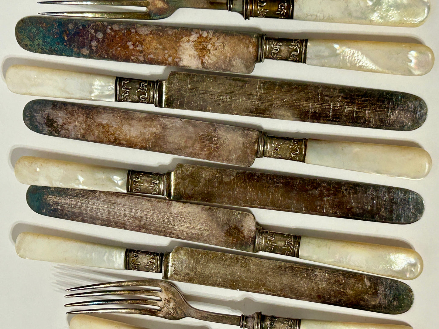 STERLING AND MOTHER OF PEARL HANDLED ANTIQUE SET OF TWELVE FORKS AND KNIVES