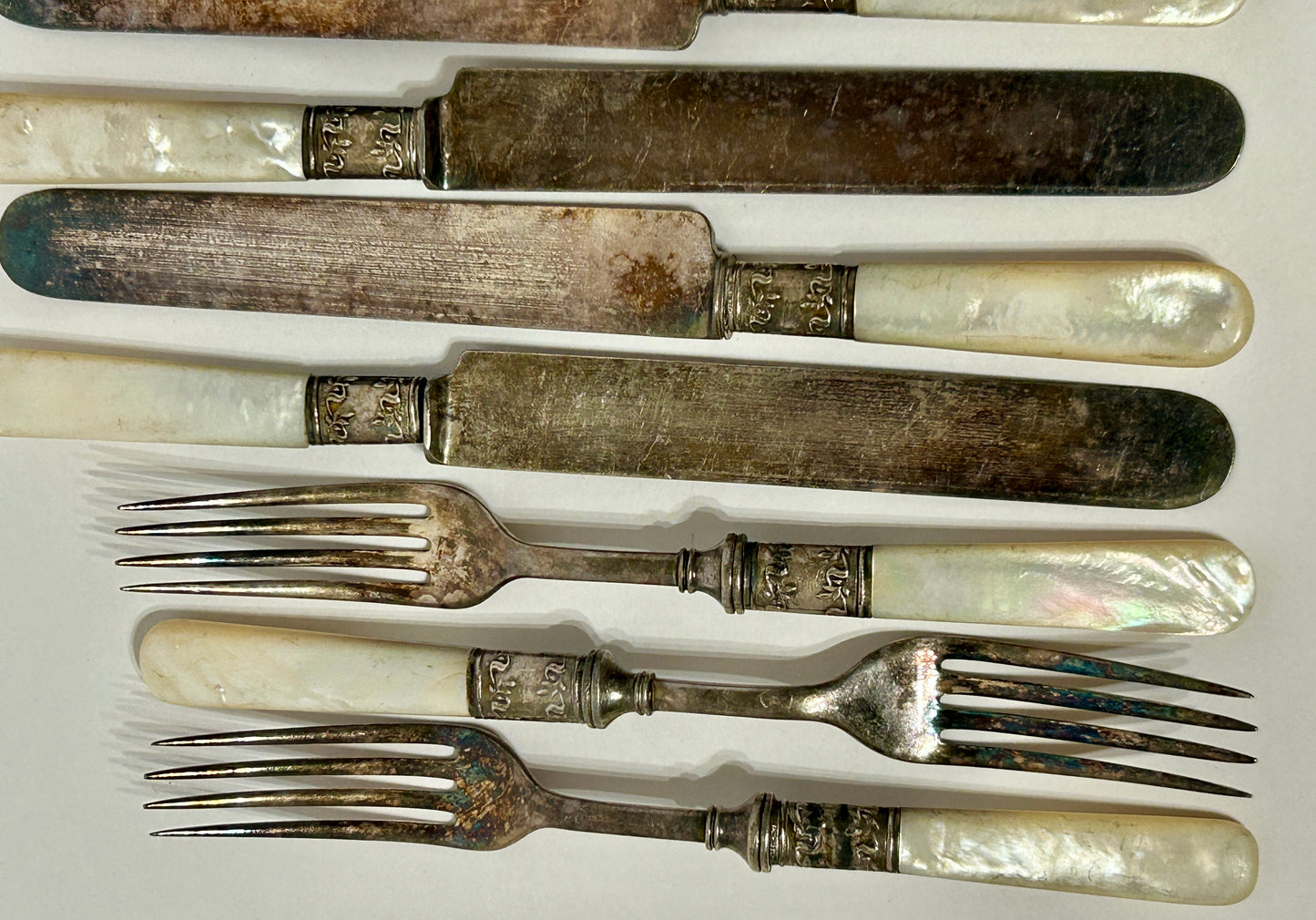 STERLING AND MOTHER OF PEARL HANDLED ANTIQUE SET OF TWELVE FORKS AND KNIVES