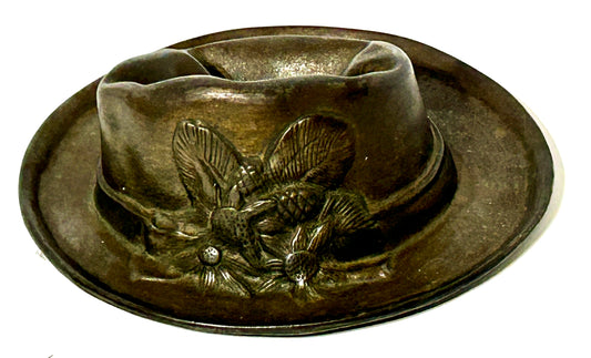 ANTIQUE CAST IRON HAT WITH SMASHED LOOK TOP