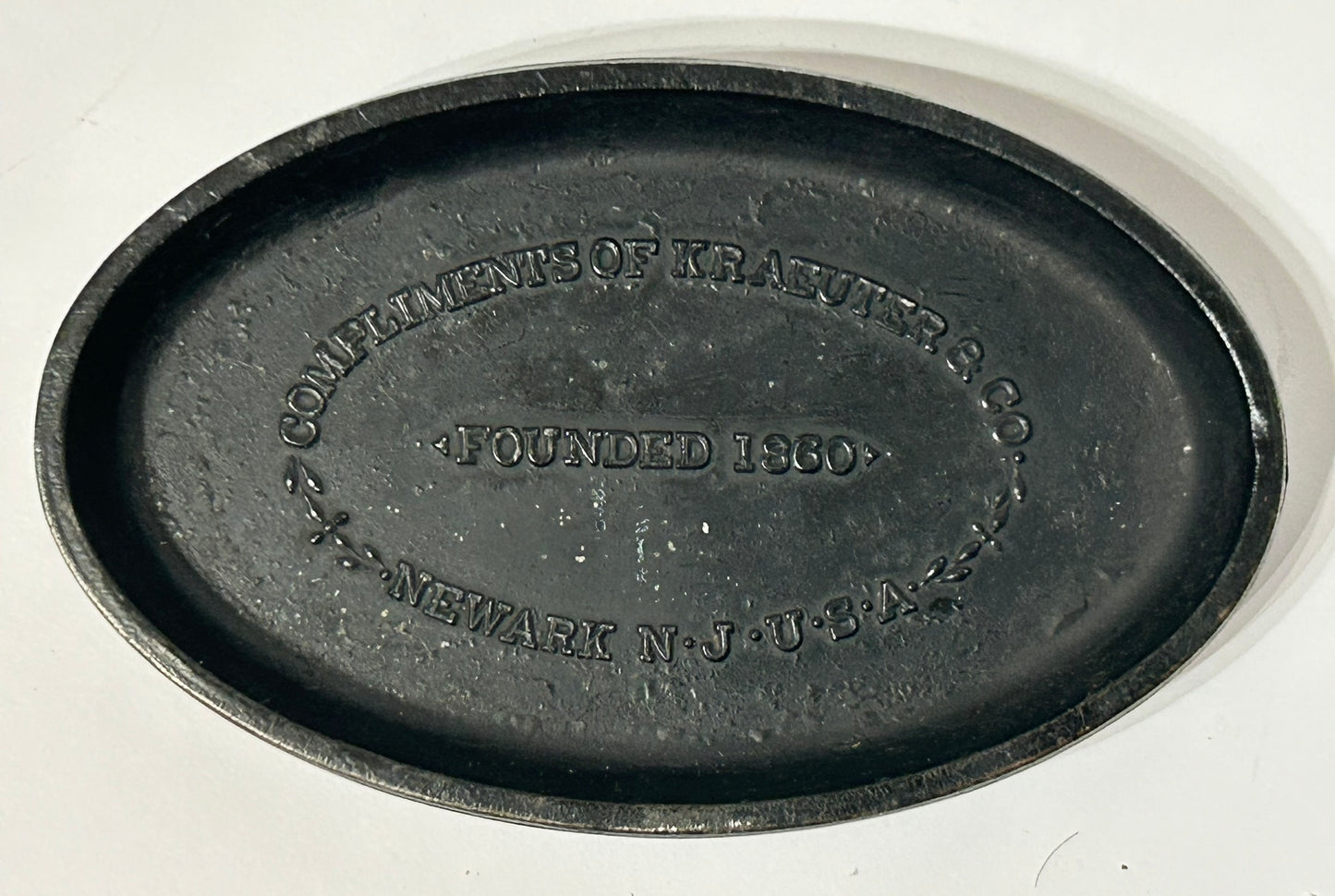 FIGURAL IRON ADVERTISING PAPERWEIGHT OF EAGLE HOLDING WRENCH FOR KRAEUTER & CO.