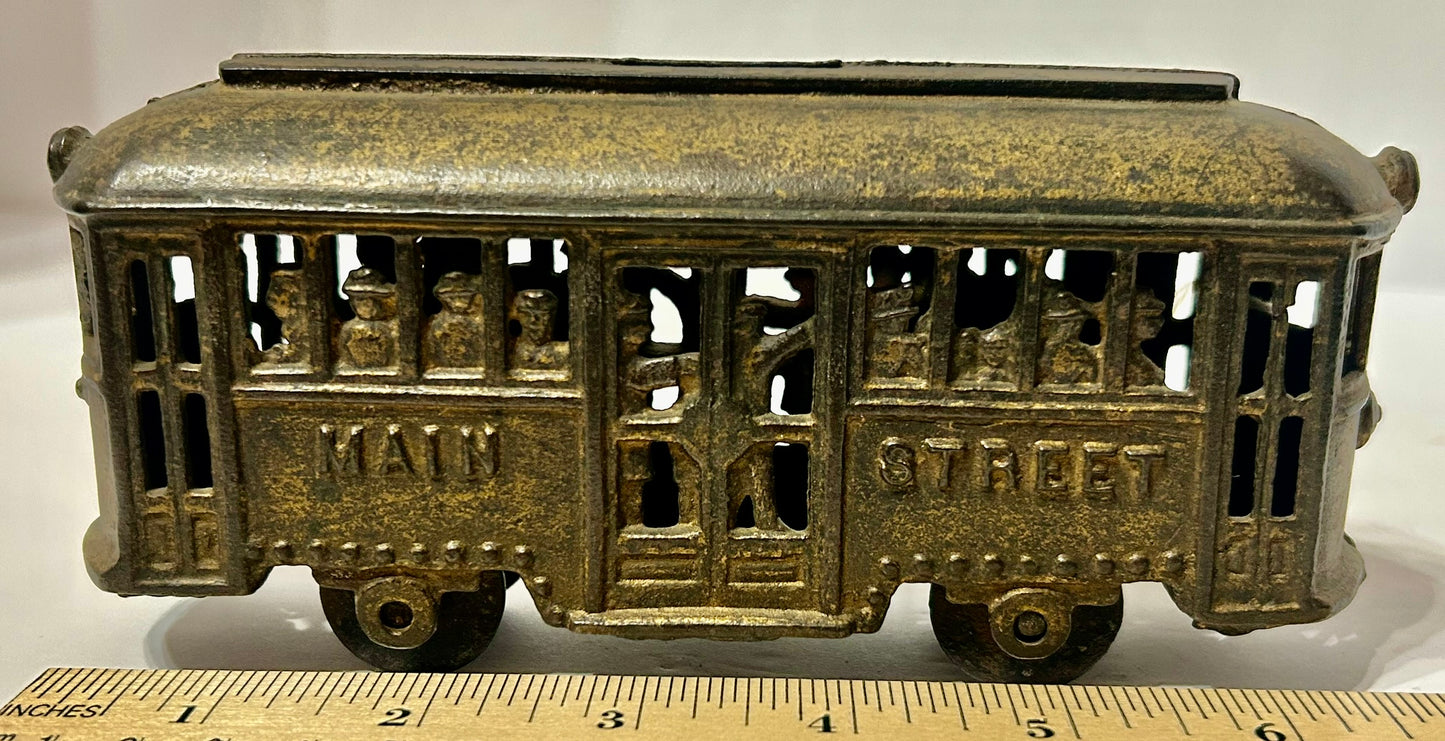 ANTIQUE CAST IRON TROLLY STILL BANK WITH PEOPLE