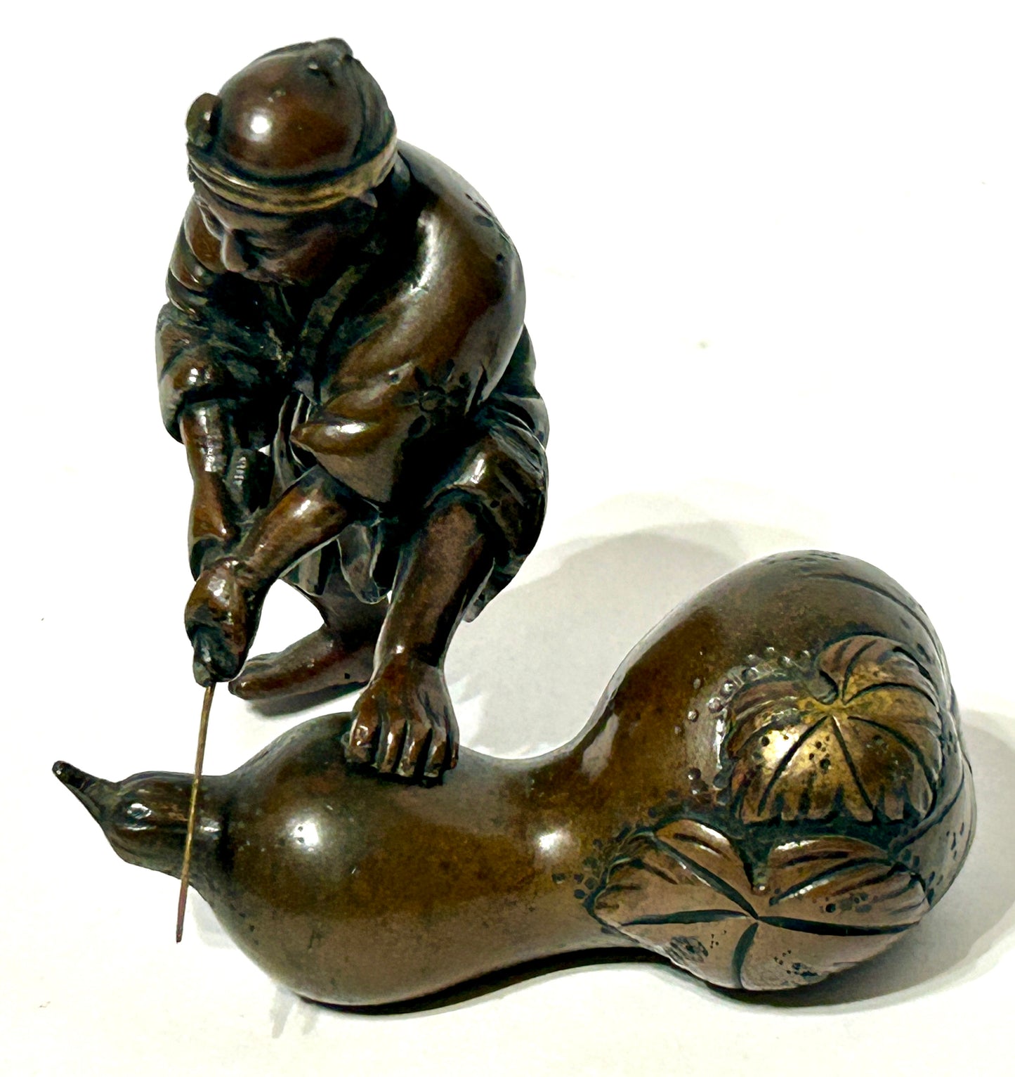 ANTIQUE ASIAN BRONZE OF MAN CUTTING GOURD