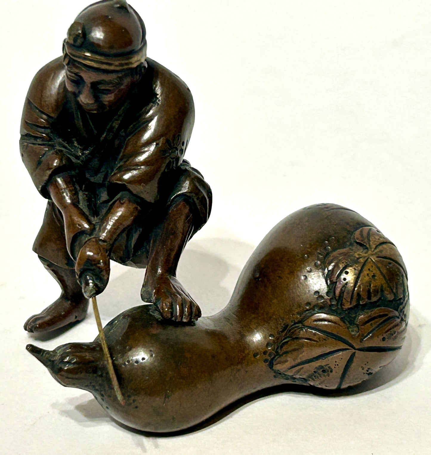 ANTIQUE ASIAN BRONZE OF MAN CUTTING GOURD
