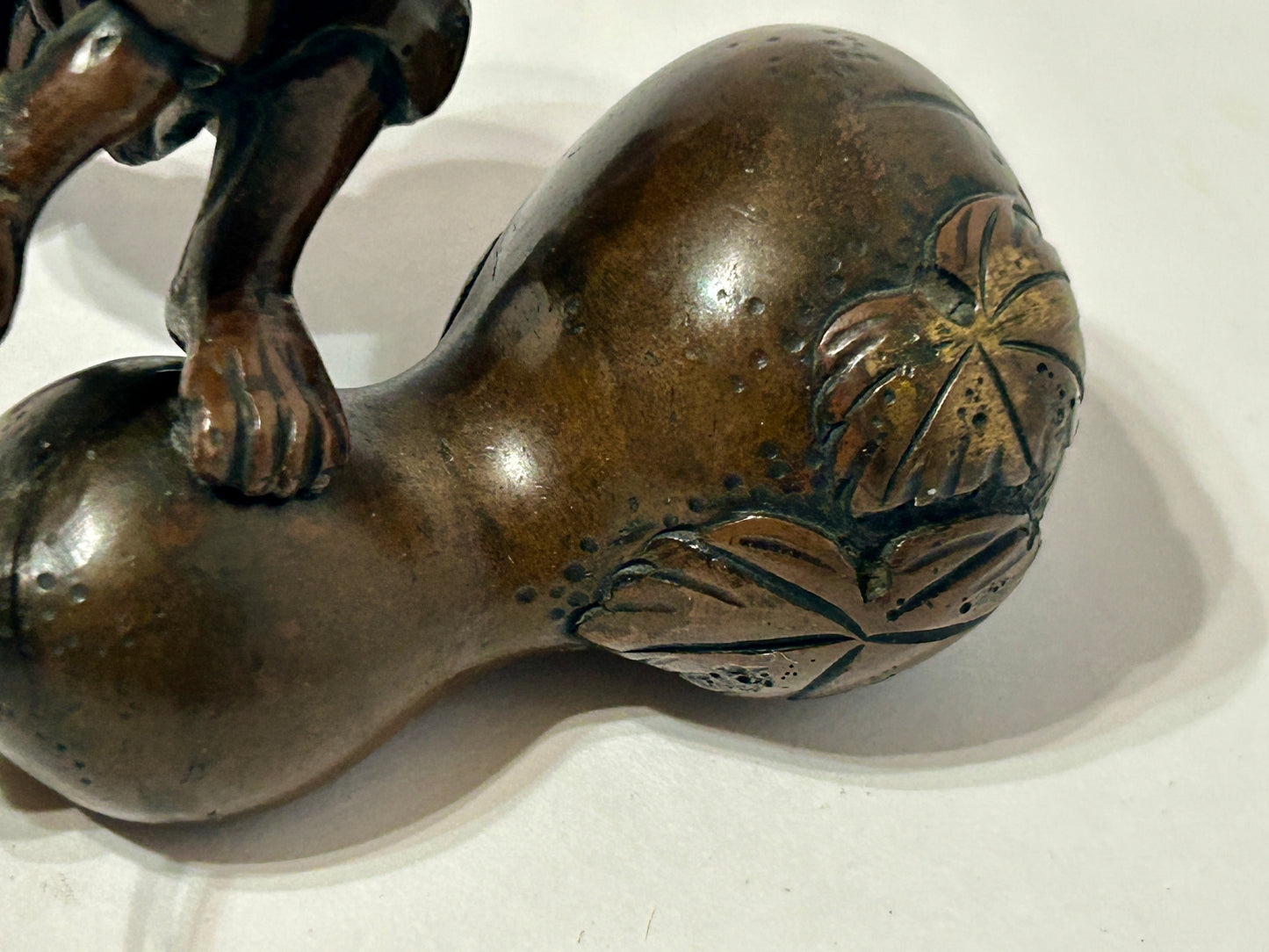ANTIQUE ASIAN BRONZE OF MAN CUTTING GOURD