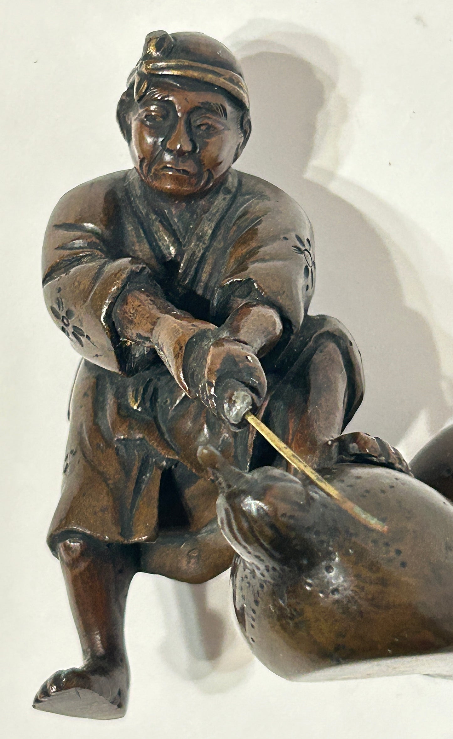 ANTIQUE ASIAN BRONZE OF MAN CUTTING GOURD