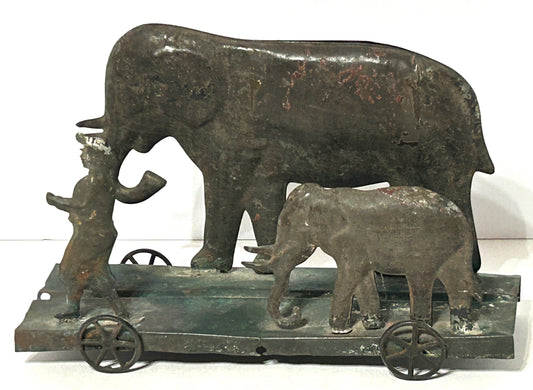 EARLY AMERICAN TIN PLATFORM TOY WITH BOY AND ELEPHANTS