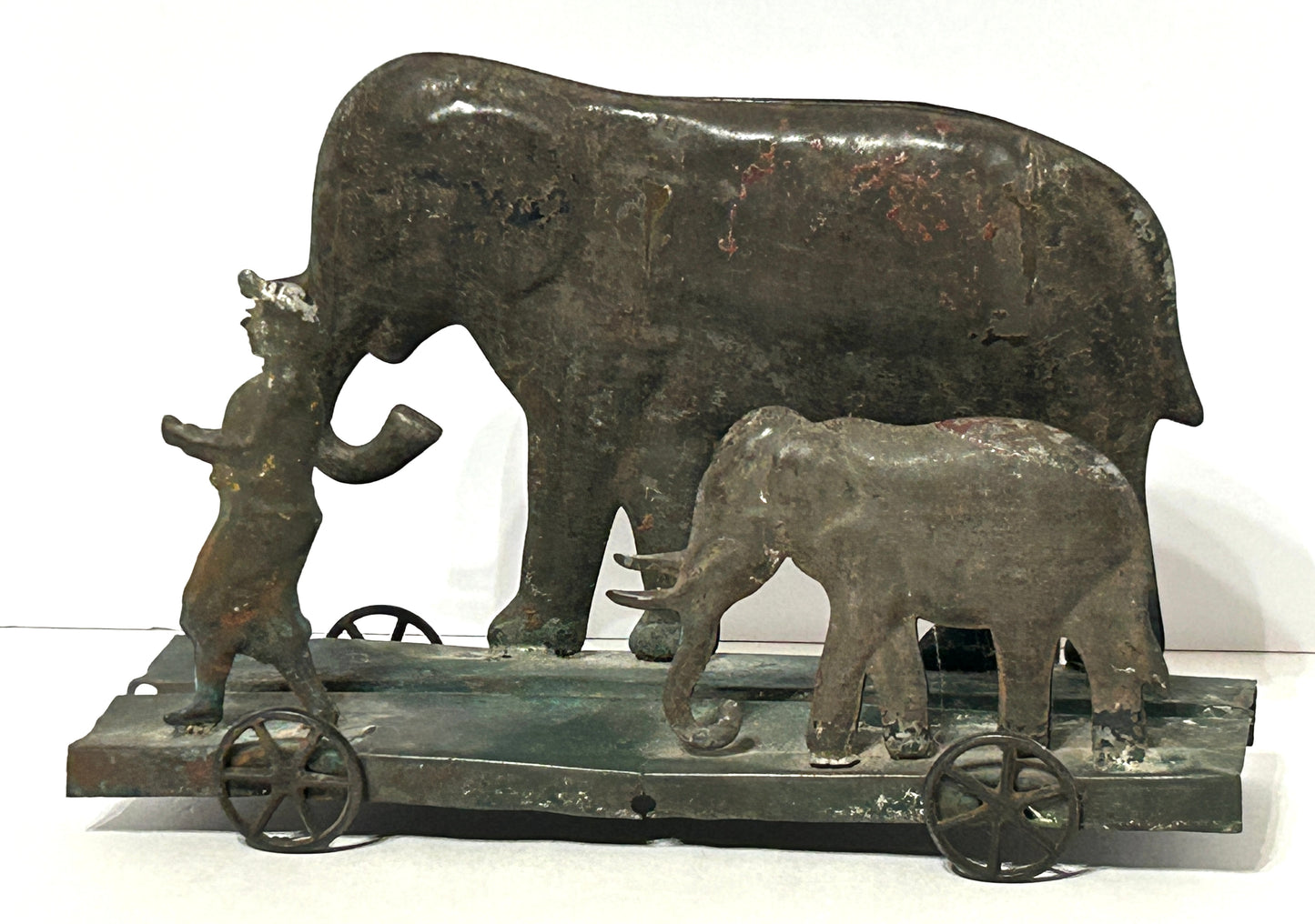 EARLY AMERICAN TIN PLATFORM TOY WITH BOY AND ELEPHANTS