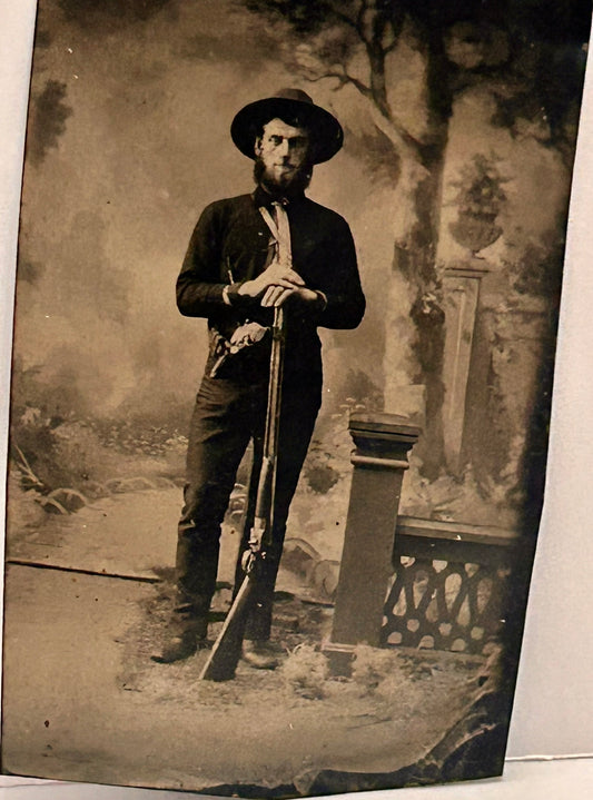 TINTYPE OF MAN WITH SHOTGUN AND PISTOL POSING
