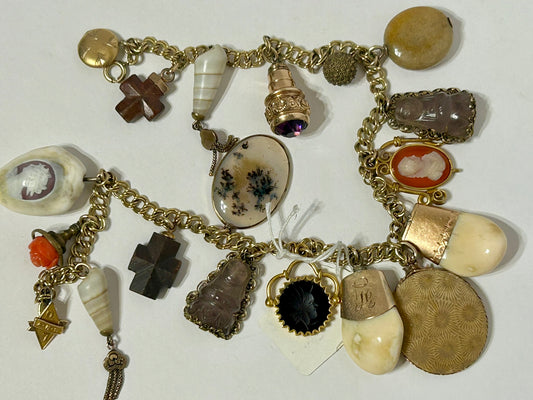 ANTIQUE CHARM BRACELET WITH TWENTY CHARMS INCLUDING ELKS TEETH AND CAMEOS,