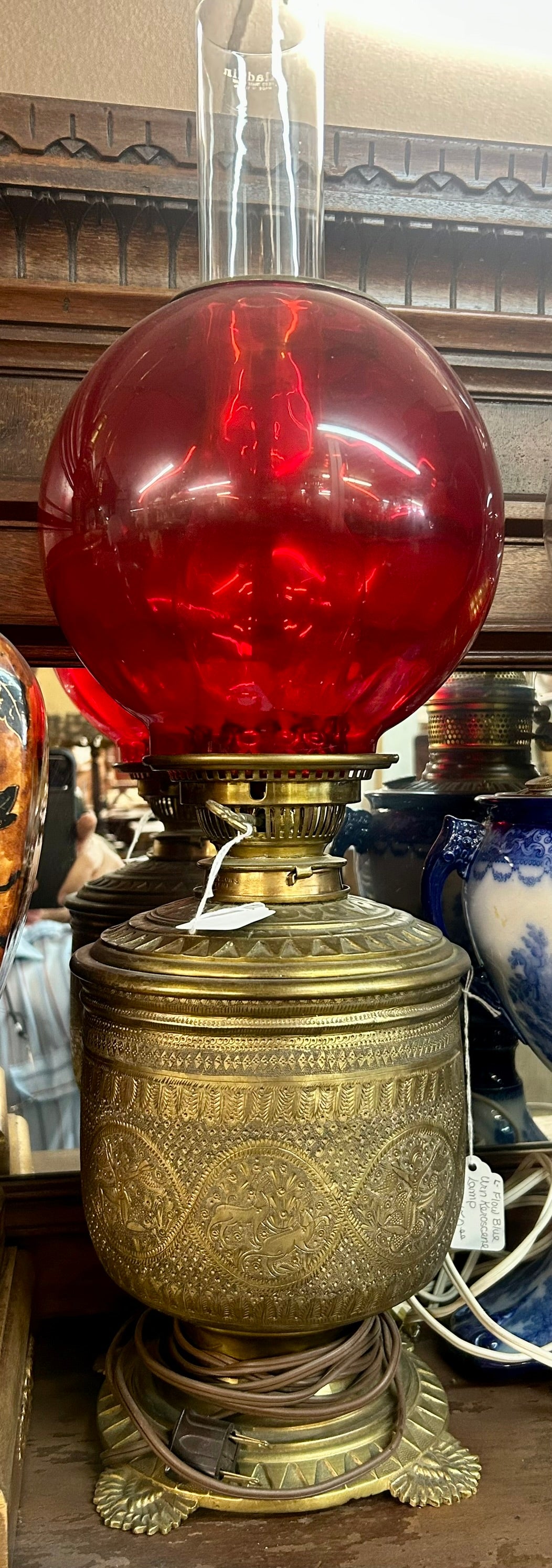 PERSIAN STYLE DECORATED BRASS LAMP BASE WITH RED GLOBE SHADE