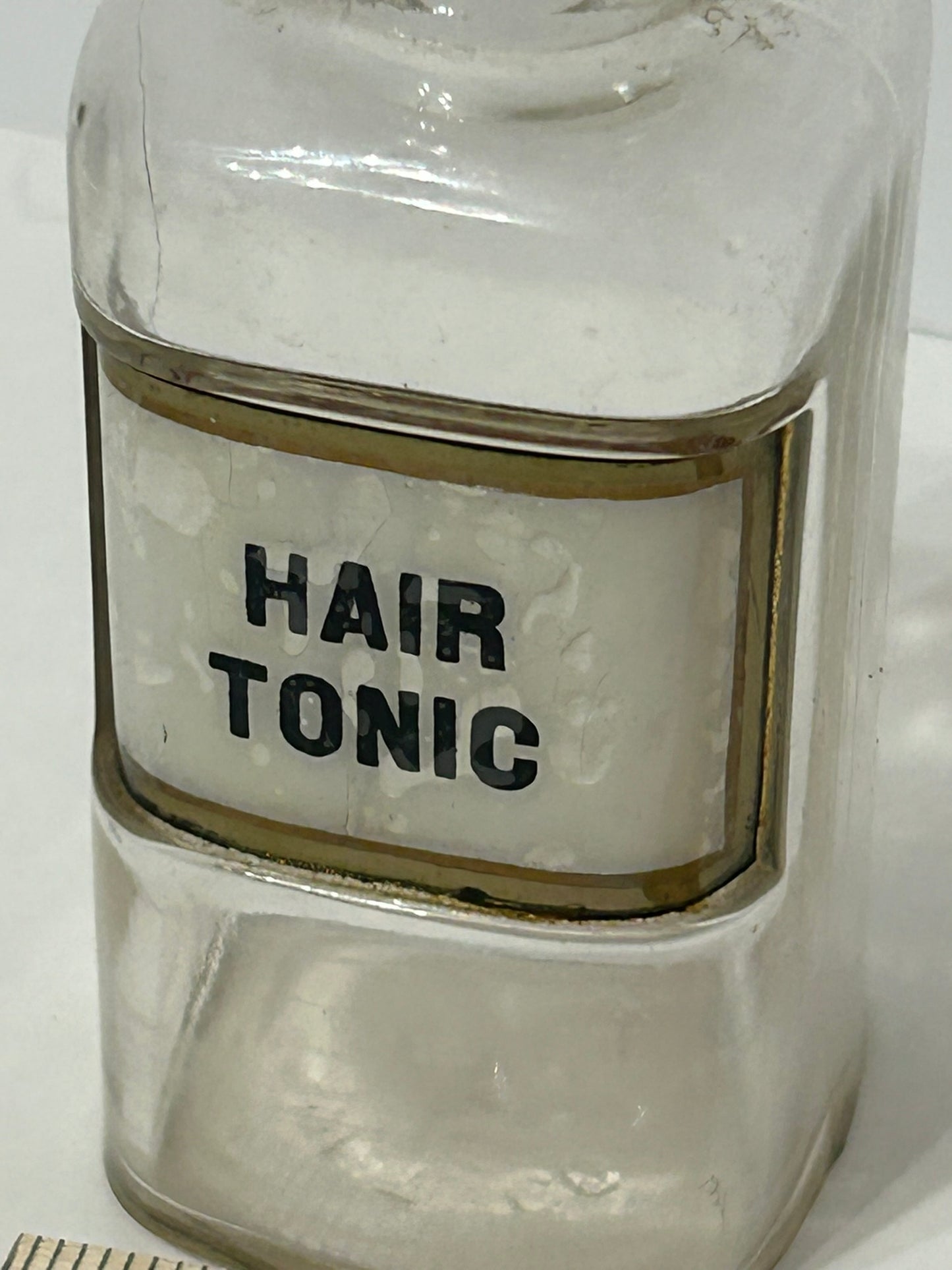 DRUGGIST BOTTLE WITH LABEL UNDER GLASS FOR "HAIR TONIC"