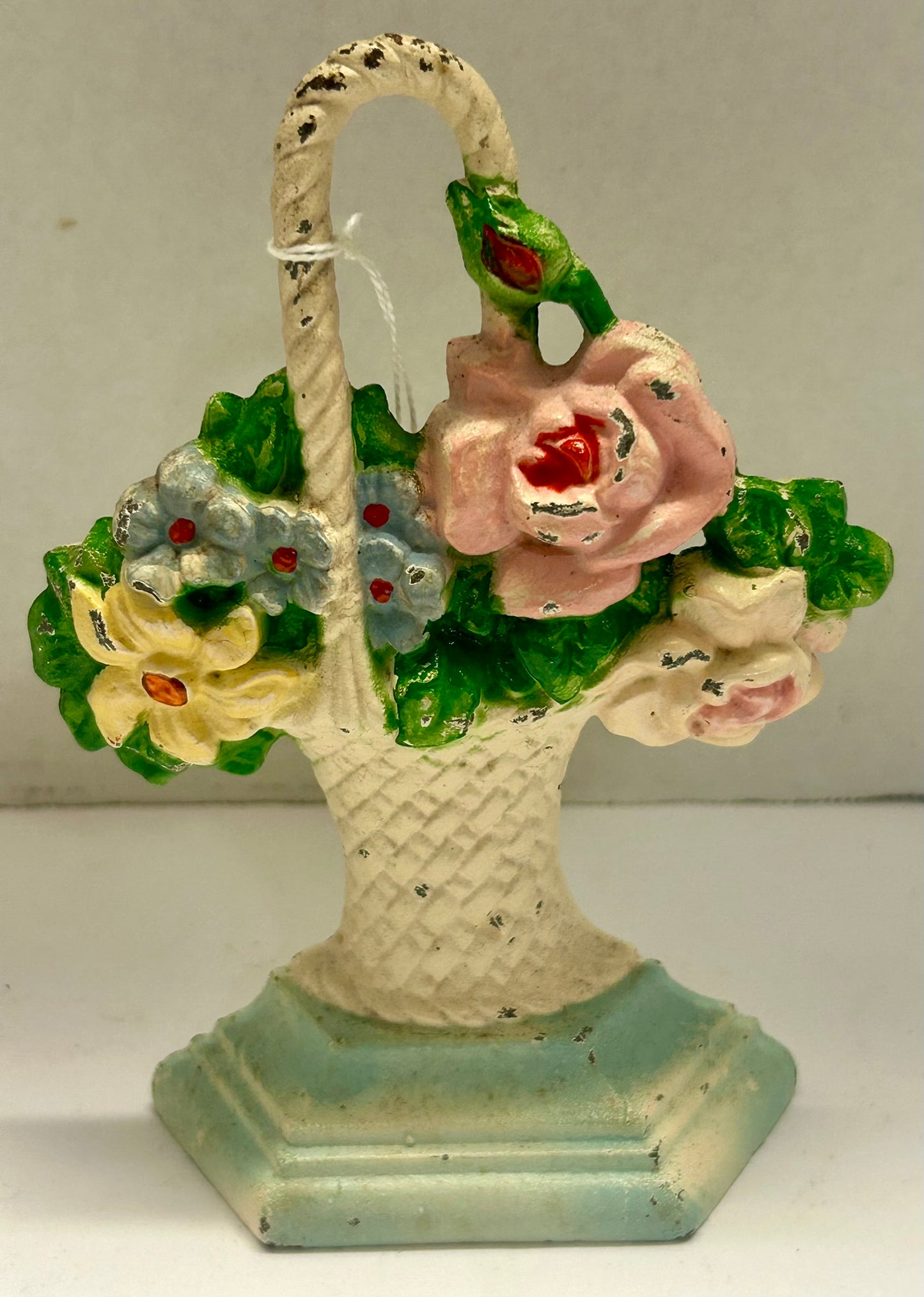 CAST IRON DOORSTOP OF BASKET OF FLORALS