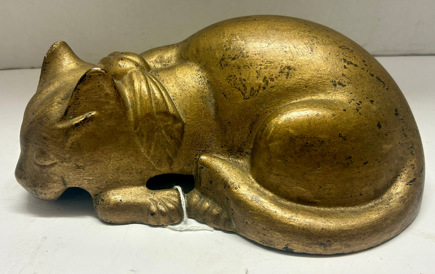 CAST IRON CAT WITH BOW LAYING DOWN ANTIQUE DOORSTOP