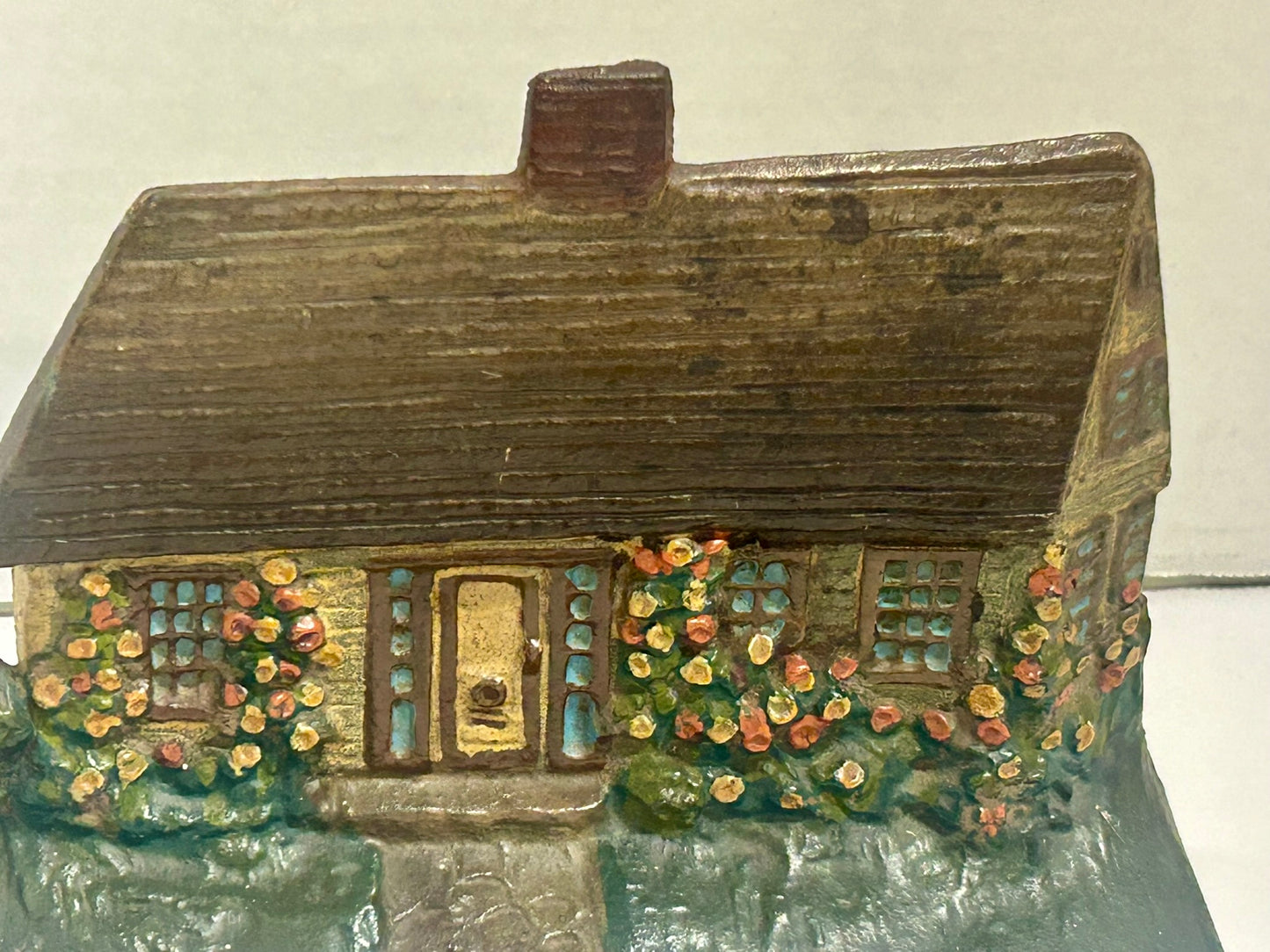 COTTAGE WITH FLOWERS CAST IRON ANTIQUE DOORSTOP