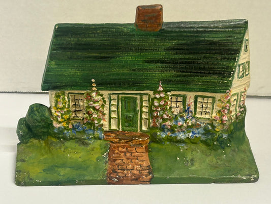 CAST IRON DOORSTOP OF COTTAGE WITH HOLLYHOCKS
