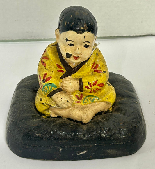 ANTIQUE CAST IRON DOORSTOP OF TAKEO ON CUSHION