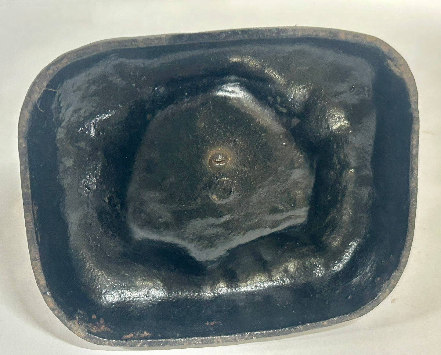 ANTIQUE CAST IRON DOORSTOP OF TAKEO ON CUSHION