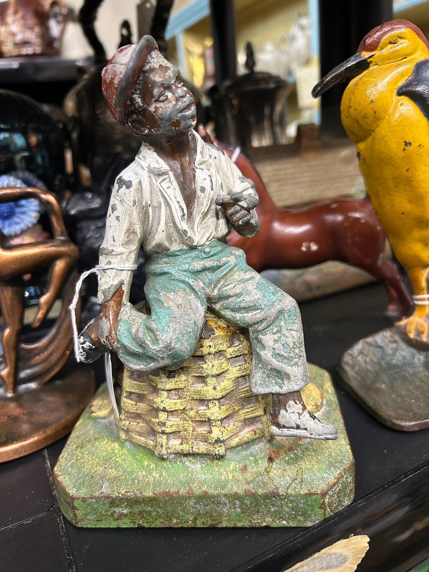 BOY ON BASKET ANTIQUE DOORSTOP