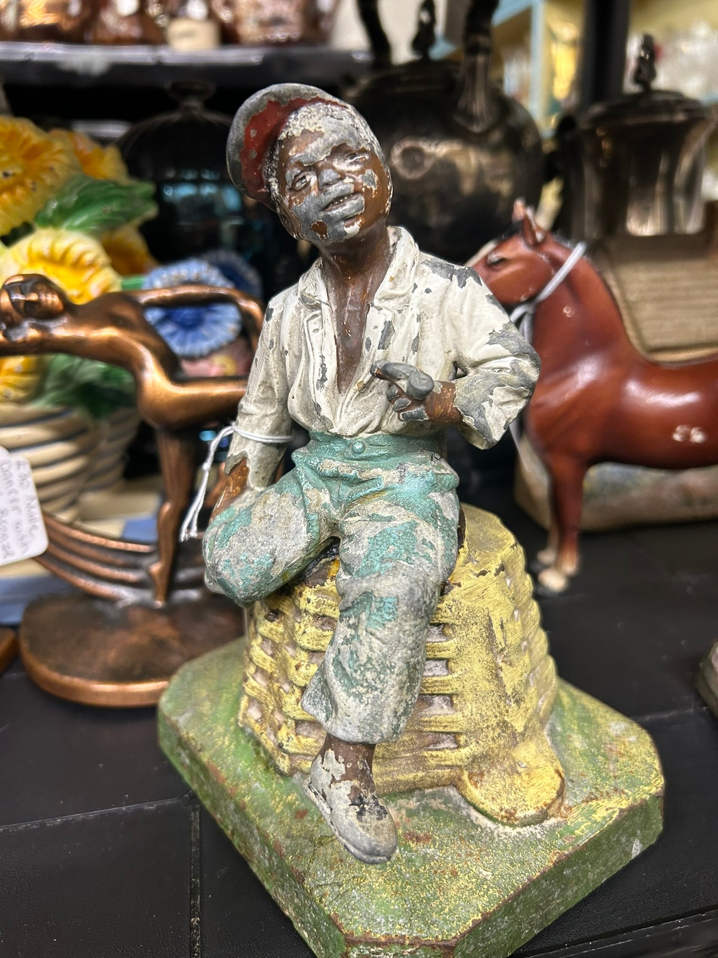 BOY ON BASKET ANTIQUE DOORSTOP