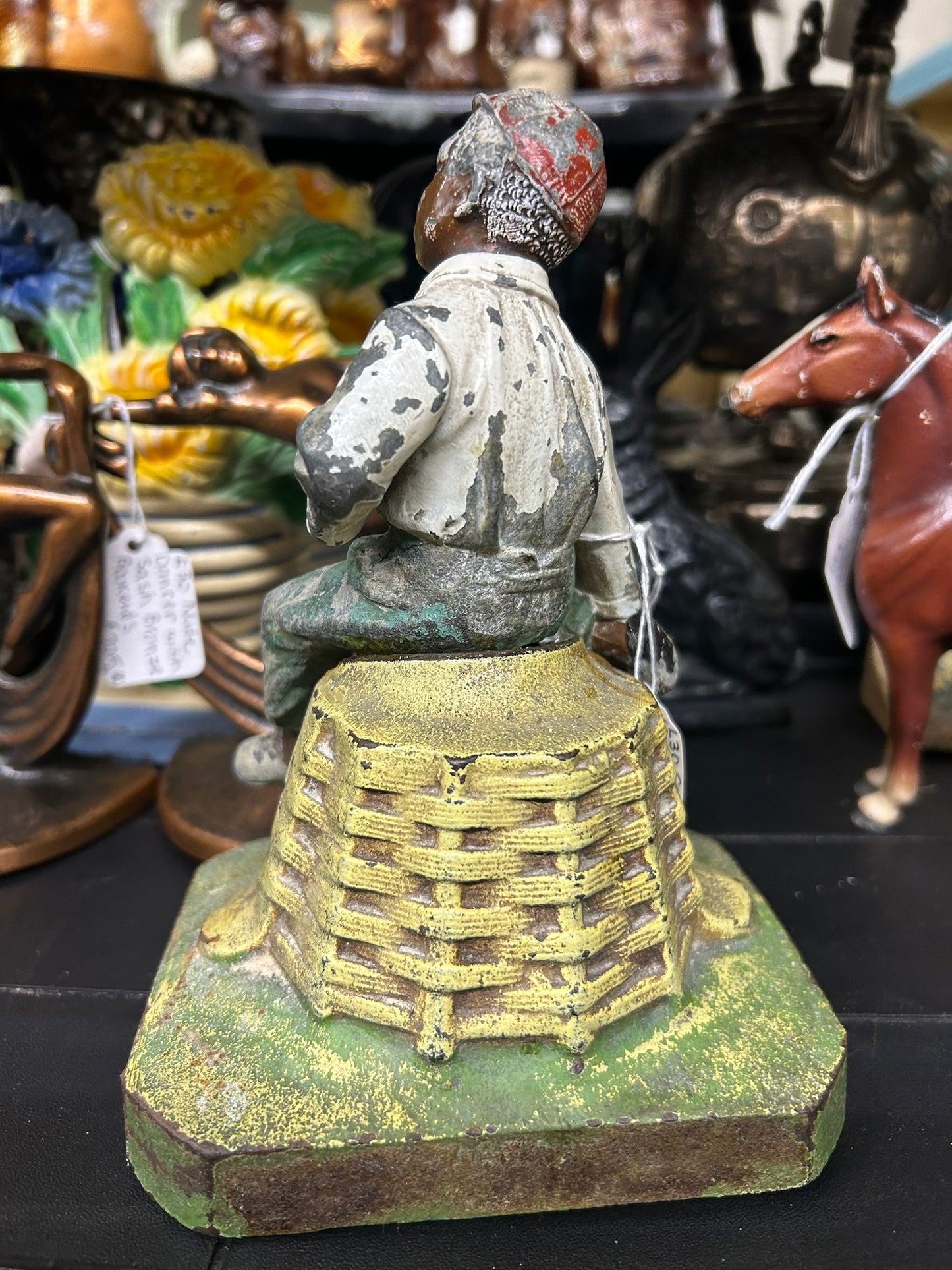 BOY ON BASKET ANTIQUE DOORSTOP