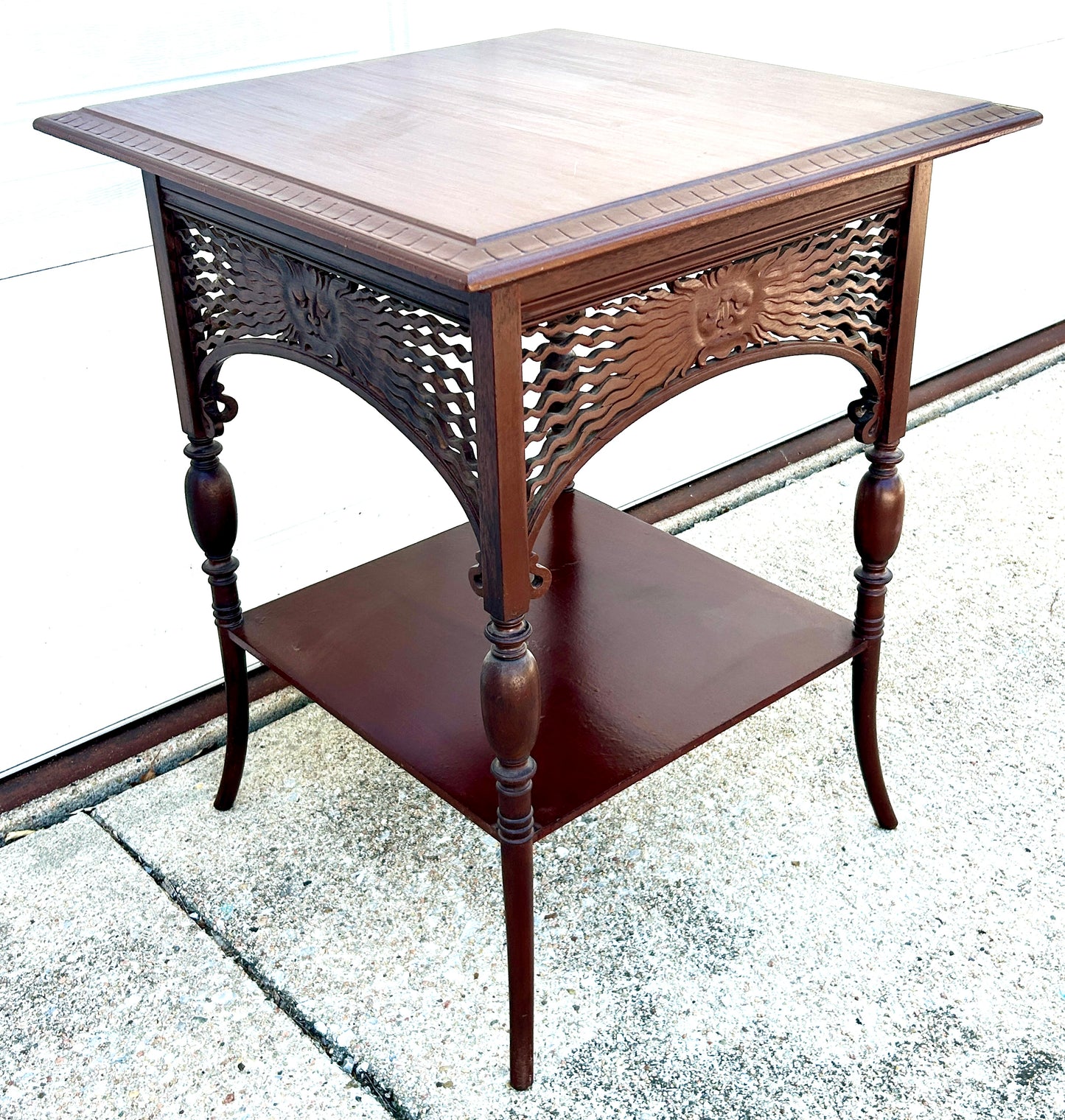 ANTIQUE MAHOGANY STAND WITH UNUSUAL SUN FACES ON SIDES