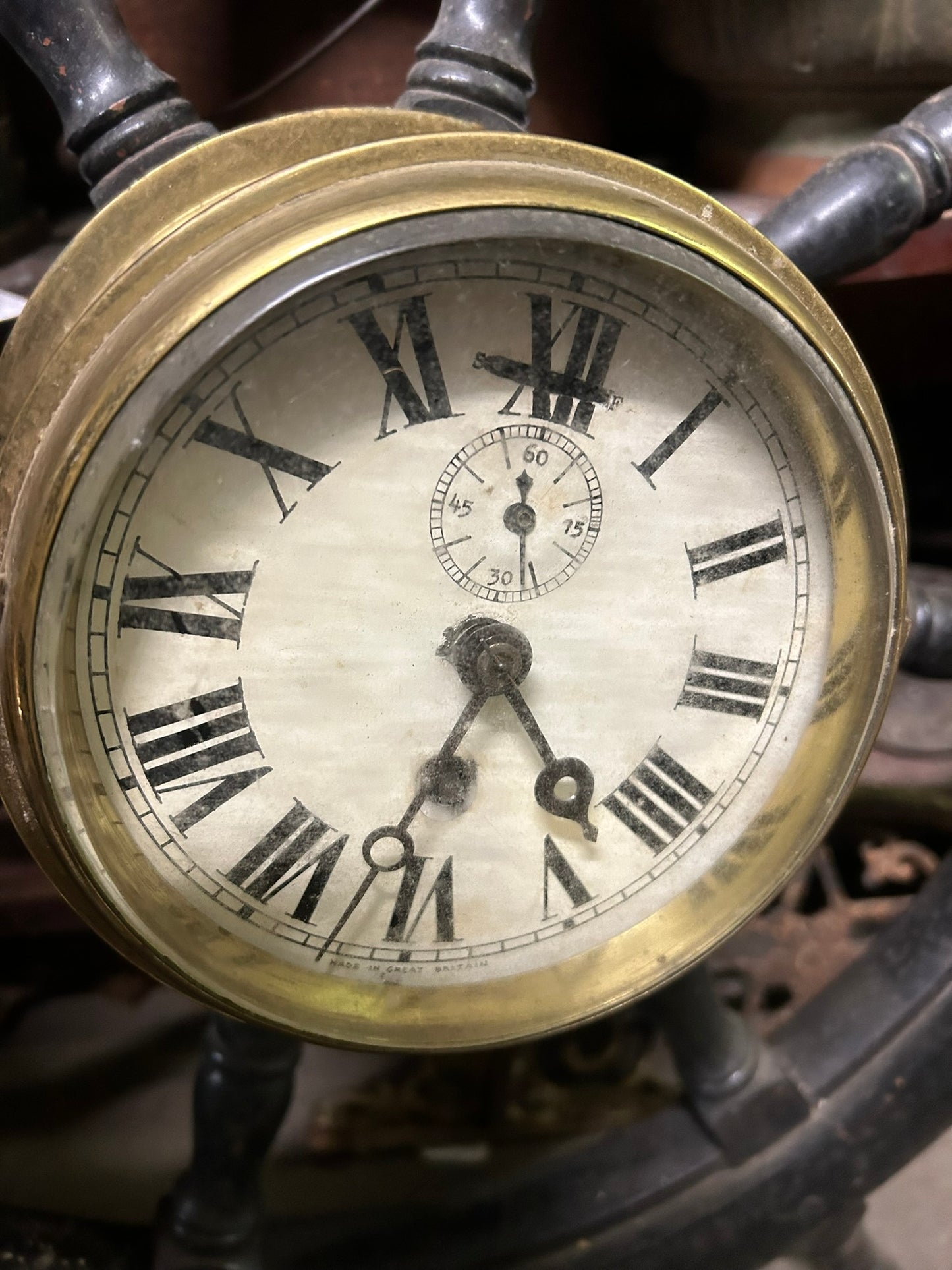 ANTIQUE WOOD SHIP'S WHEEL WITH ANTIQUE BRASS CLOCK IN CENTER