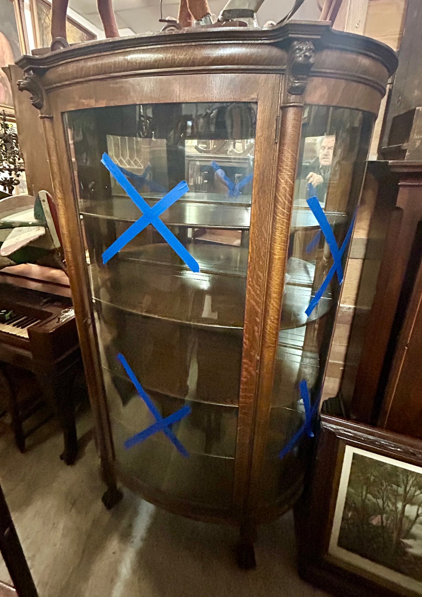 ANTIQUE OAK TRIPLE CURVED GLASS CHINA CABINET WITH CARVED HEADS