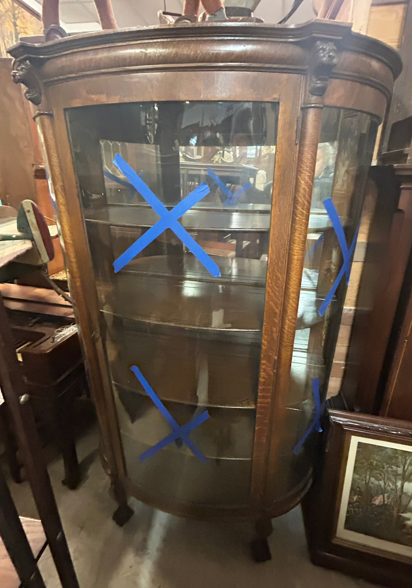 ANTIQUE OAK TRIPLE CURVED GLASS CHINA CABINET WITH CARVED HEADS