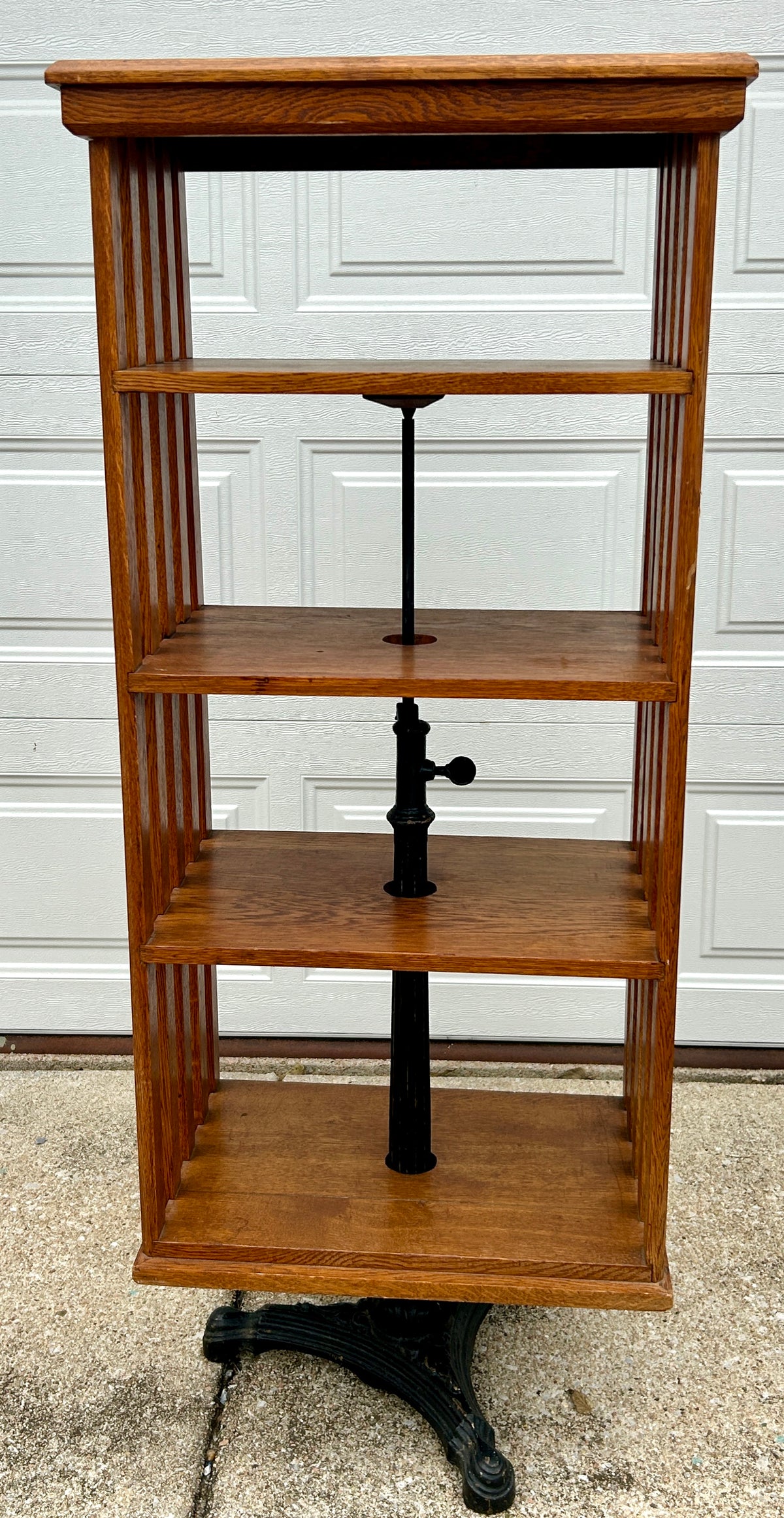 ANTIQUE OAK REVOLVING STANDING BOOKCASE MANFACTURED BY ON ORNATE CAST IRON BASE