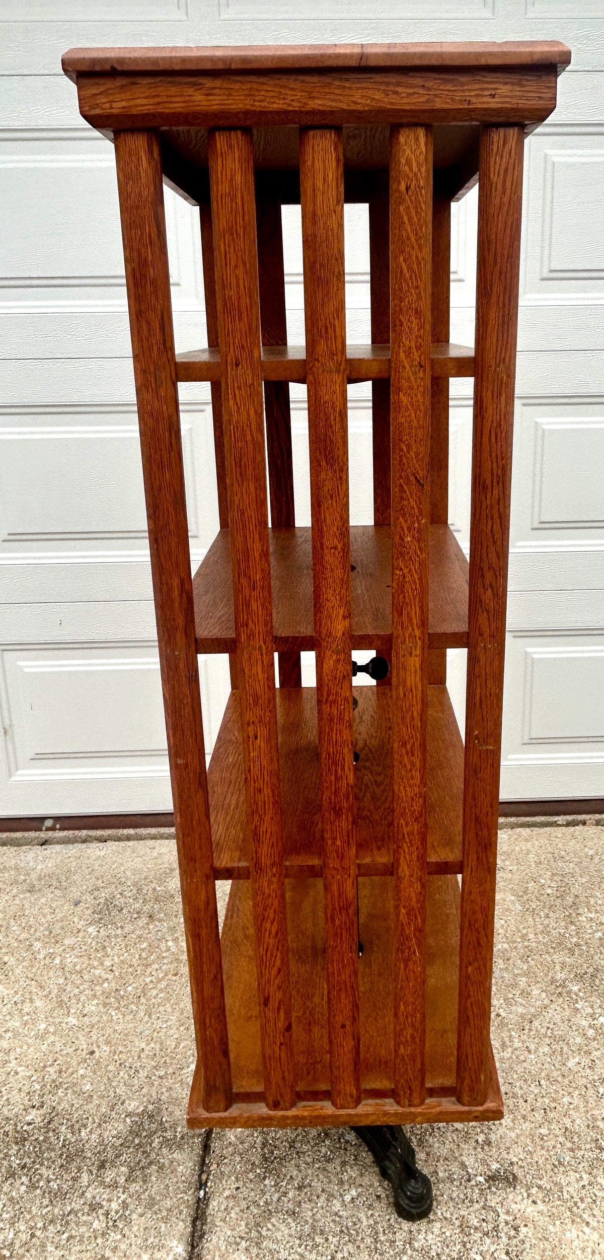ANTIQUE OAK REVOLVING STANDING BOOKCASE MANFACTURED BY ON ORNATE CAST IRON BASE