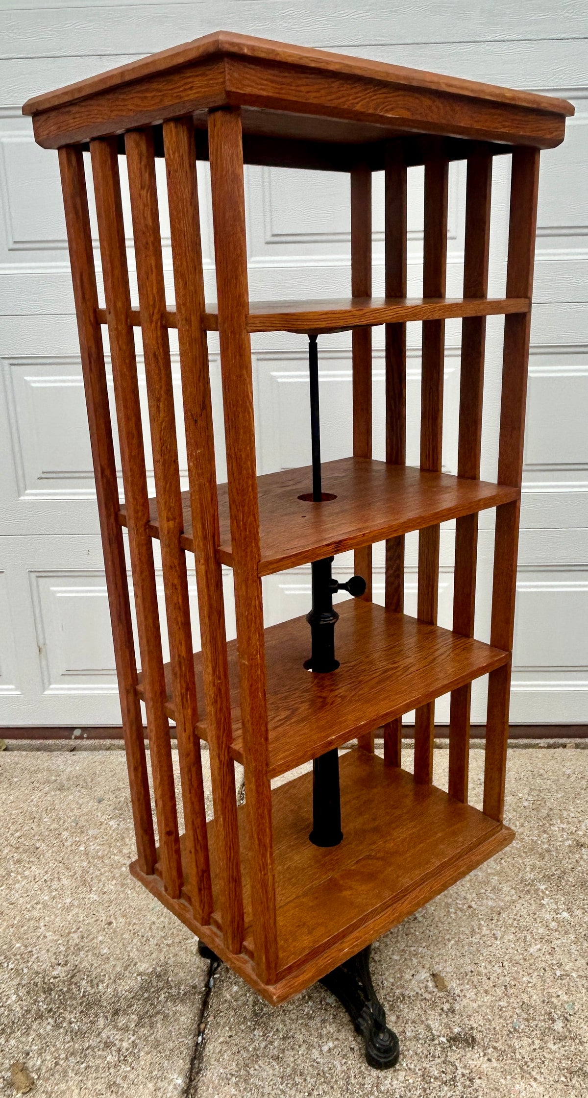 ANTIQUE OAK REVOLVING STANDING BOOKCASE MANFACTURED BY ON ORNATE CAST IRON BASE