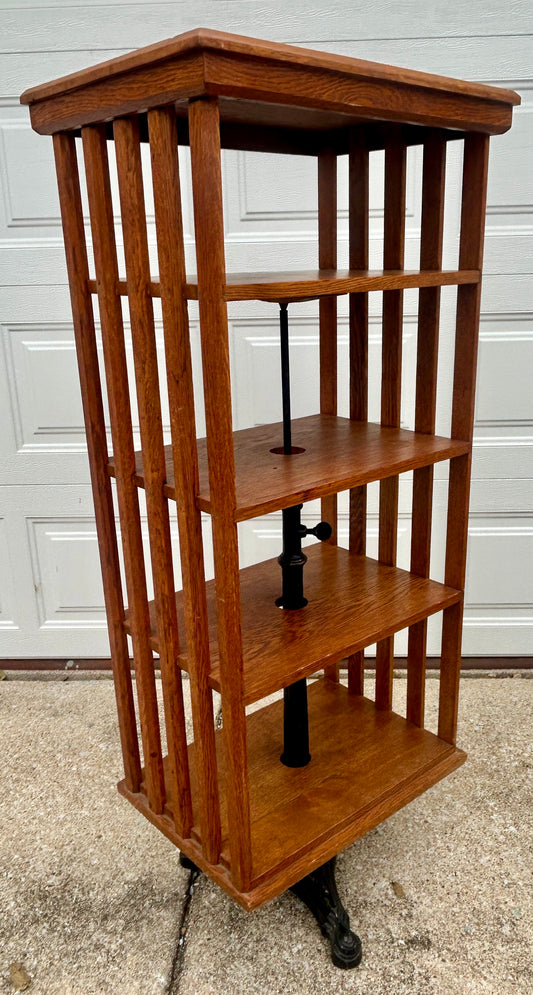 ANTIQUE OAK REVOLVING STANDING BOOKCASE MANFACTURED BY ON ORNATE CAST IRON BASE